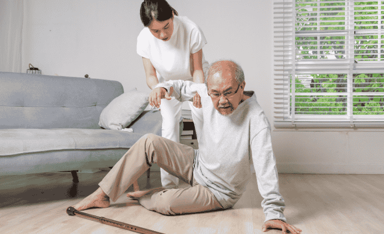 Fall prevention for seniors- A family caregiver is helping senior to stand up